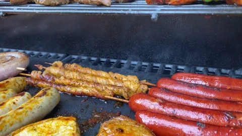 Slow motion close up shot of delicious meat being cooked on BBQ grill in Stock Footage 136735788
