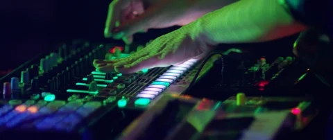 Slow motion close up shot of DJ's hands above mixer table at rave party, Japan Stock Footage 128968675