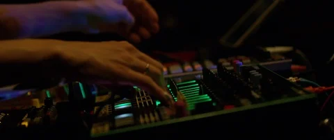 Slow motion close up shot of DJ's hands above mixer table at rave party, Japan Stock Footage 128970017
