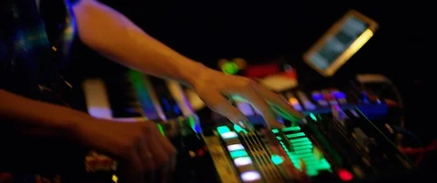 Slow motion close up shot of DJ's hands above mixer table at rave party, Japan Stock Footage 128971130