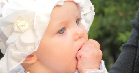 Slow Motion Close-Up Shot of Five Months Baby Girl Sitting Outdoors in a Stock Footage 111058470