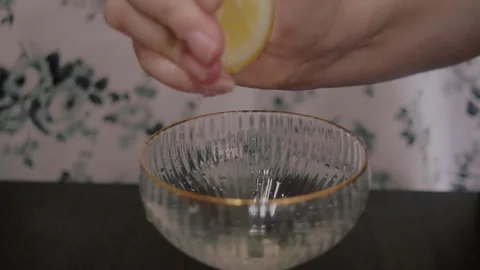 Slow Motion Close Shot of Hand Squeezing Juice From a Lemon Stock Footage 243770982