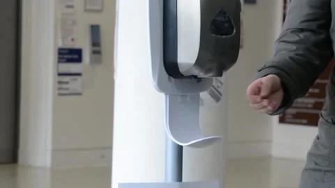 Slow motion, close shot of hands taking gel sanitizer from dispenser Stock Footage 131543751