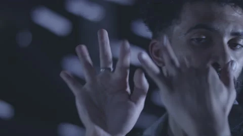 Slow motion close up shot of islamic guy dancing with his hands in dark room Stock Footage 211869254