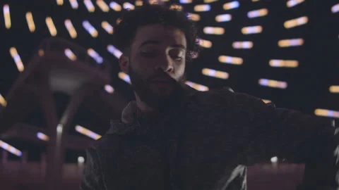 Slow motion close up shot of islamic guy dancing in dark room with lights Stock Footage 211869624