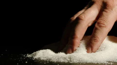 SLOW MOTION: Close shot of male's hand touching sugar inside Stock Footage 107501415