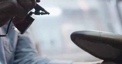 Slow motion close up shot of a man painting a shoe. Stock Footage 71972168