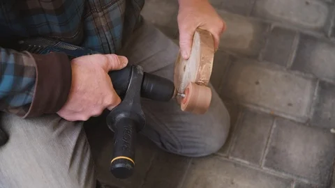 A slow-motion close up shot of a man using sanding drill sanding a piece Video stock 120744775