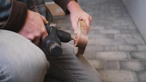 A slow-motion close up shot of a man using sanding drill sanding a piece Video stock 120744853