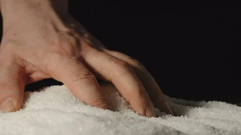 SLOW MOTION: Close shot of man's hand touching salt inside Vídeo Stock 107501392