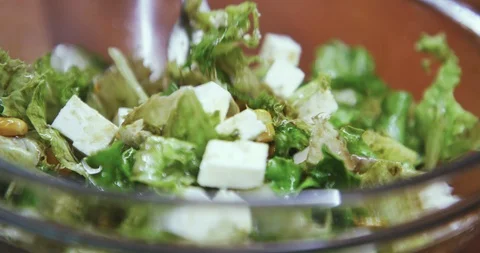 Slow motion close up shot, mixing fresh salad with fork. Stock Footage 120249204