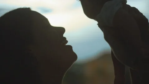 Slow motion close-up shot of mother holding her baby up Stock Footage 113036368