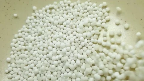 Slow motion close-up shot of pouring sago grain into a white ceramic bowl. Video stock 159442362