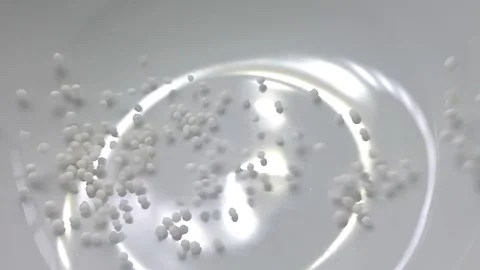 Slow motion close-up shot of pouring sago grain into a white ceramic bowl. Video stock 159442383