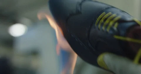 Slow motion close up shot of shoe being glued with fire. Stock Footage 71971331