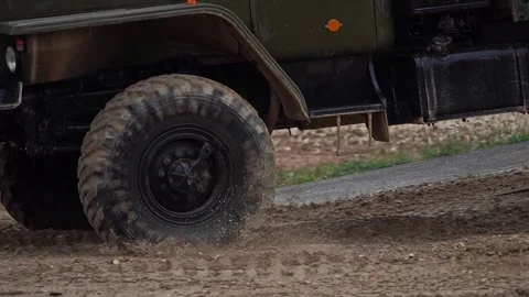 Slow motion close-up shot of spinning wheels of a military trucks Stock Footage 79556222