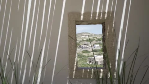 Slow motion close up shot of window looking at a village, focus on the village Stock Footage 257950465