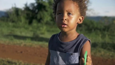 Slow motion close up shot of a young mixed raced child flying a kite in Stock Footage 108473396