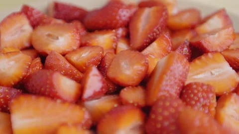 Slow motion. close-up. sliced strawberries fall on a plate. Stock Footage 132320667