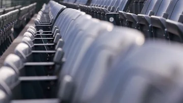 Slow motion close-up slider shot along aisle of empty seats in football stadium Stock Footage 85758843