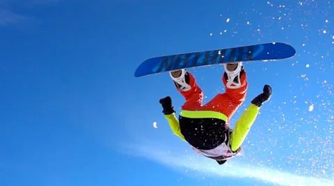 SLOW MOTION CLOSE UP: Snowboarder makes the rotation in the air over the camera. Stock Footage 60937727