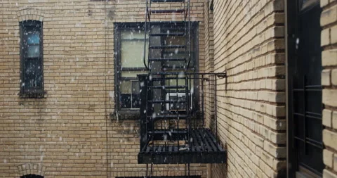 Slow motion close up of snowflakes on a cloudy day. Brick wall Stock Footage 149495666