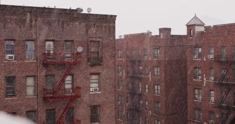 Slow motion close up of snowflakes on a cloudy day. Brick wall Stock Footage 149500757