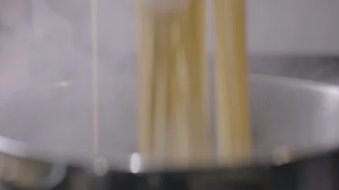 Slow Motion Close Up of Spaghetti in Boiling Water Pan Stock Footage 128996126