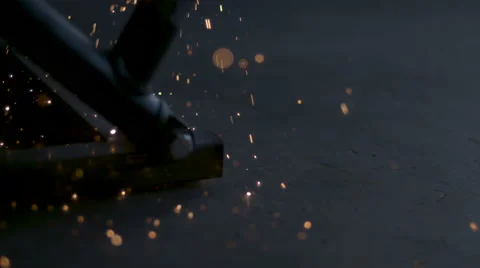 Slow motion close up of sparks raining onto the floor in an auto garage. Stock Footage 64092201
