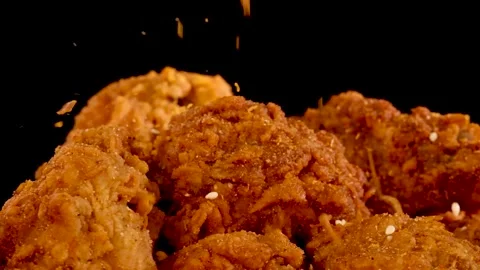 Slow Motion Close Up of Spices Falling on Crispy Fried Chicken 스톡 동영상 329144985