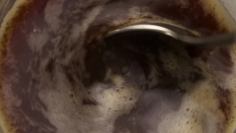 Slow motion close-up of a spoon stirring a cup of coffee Stock-Footage 237564210