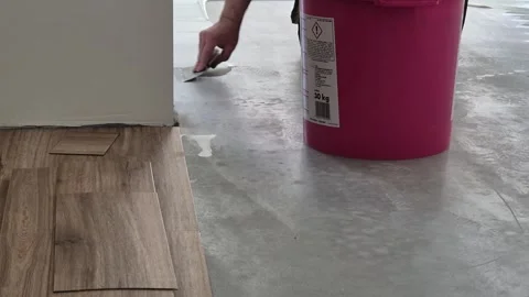 Slow motion close up of spreading parquet adhesive with notched trowel Stock-Footage 335068770