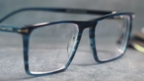 Slow motion close up of stylish blue and black eyeglasses frames on texture.. Stock Footage 333153441