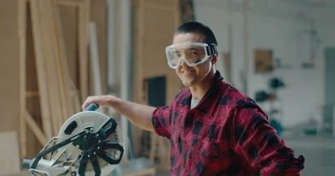 Slow motion of close up of success carpenter looking and smiling at the camera Stock Footage 199621893