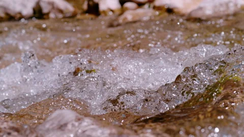 SLOW MOTION, CLOSE UP: Surface of wild mountain river glistening in summer sun Stock Footage 235192206