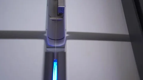 Slow motion close up of a thread being passed through a thread tester Stock Footage 257763001