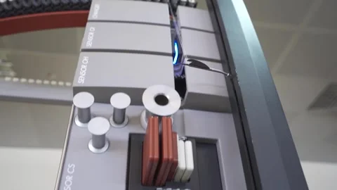 Slow motion close up of a thread being passed through a thread tester Stock Footage 257763557