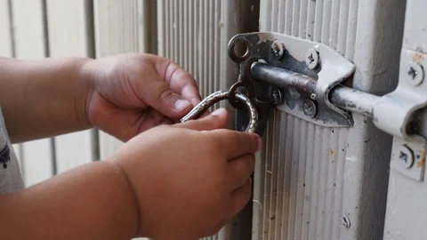 Slow motion close up of toddler hands playing with a lock and keys Stock Footage 100522566