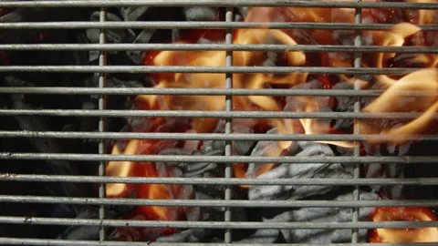 Slow motion close-up top view charcoal on the grill ignites and burns Stock Footage 145831850
