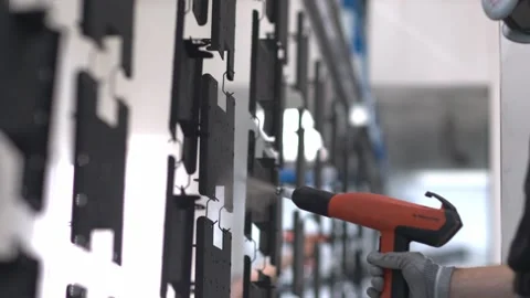 Slow motion close up tracking shot of an industrial emplyee, painting a Stock Footage 247315062