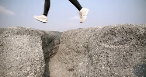 SLOW MOTION, Close up Trail running in the rock mountain rubble high jumping Stock-Footage 124410907