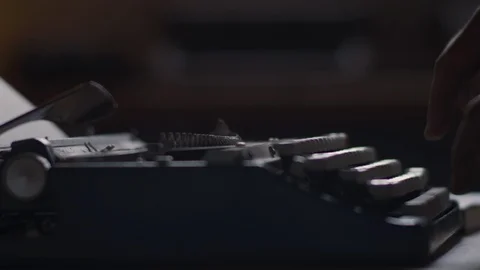 Slow motion close up of typing on a vintage typewriter with dust flying into the Stock Footage 97875715