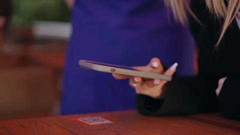 Slow motion. Close-up. An unrecognizable girl points her cell phone camera at a Stock Footage 278607705