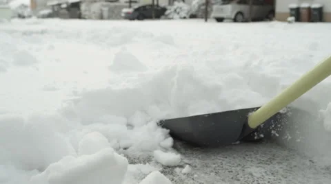 SLOW MOTION CLOSE UP: Unrecognizable person removing deep snow from parking lot Stock Footage 68587780