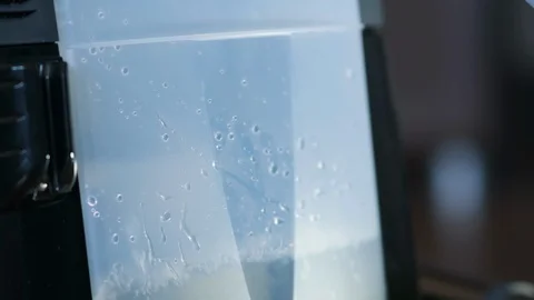 Slow motion close-up vacuum cleaner tank pour water 库存影片 122073713