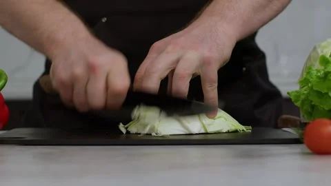 Slow-motion close-up video of cabbage being chopped by a chef in the kitchen Stock Footage 269120406