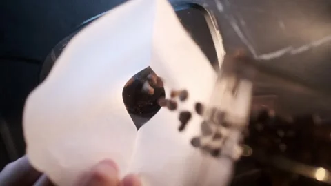 Slow motion close-up video of pouring coffee beans into a glass bowl. Stock Footage 295188184