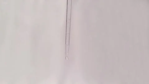 Slow Motion Close Up Video Of Water Dripping From A Dropper Stock Footage 267872061