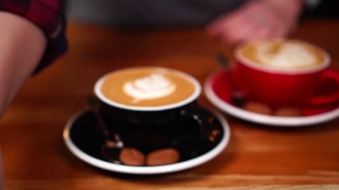 Slow motion close up view on barista hand serving coffee moving wave on small Stock-Footage 104513647