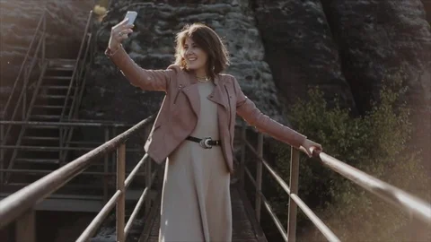 Slow motion. Close view. Beautiful woman walking along bridge in the mountains Stock-Footage 120387547